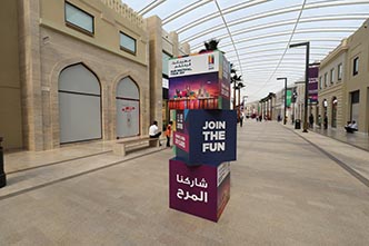 Shop Bahrain: stacked “Join the fun” totem in a souq-style street, creative direction by Bashar Daas