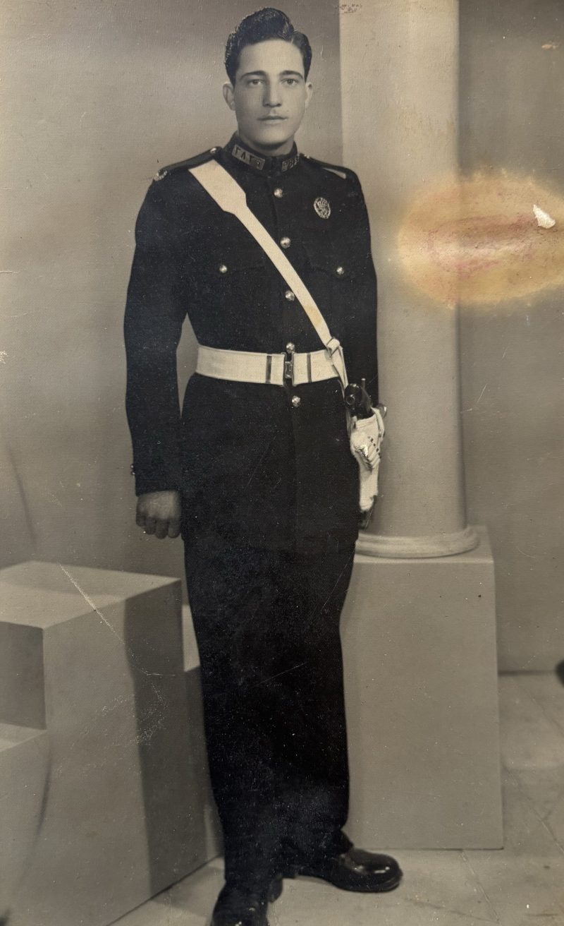 The original 80-year-old photograph: Bashar Daas's grandfather in his police academy dress uniform, in faded sepia with a stain across the right side