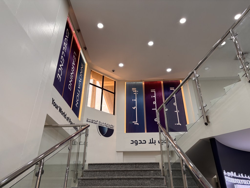 Bahrain Polytechnic: stairwell banners in the new identity with Arabic and English messages, creative direction by Bashar Daas