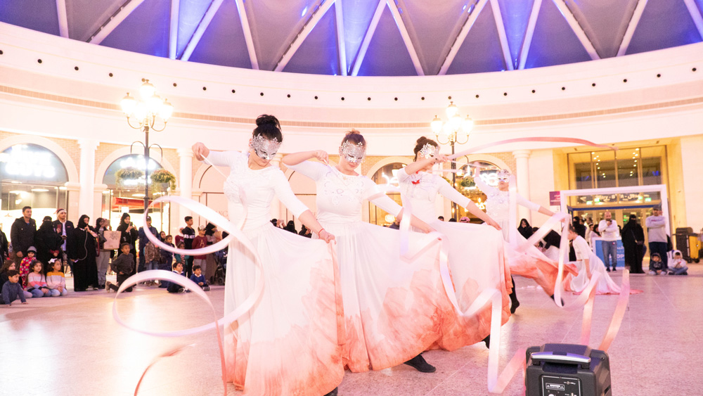 Shop Bahrain: performers dancing with ribbons in a mall atrium, creative direction by Bashar Daas